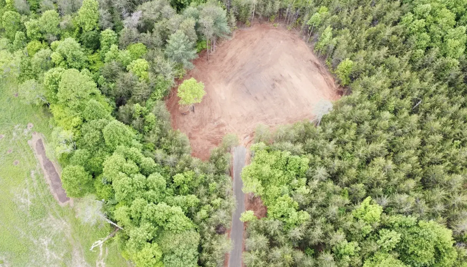 An aerial view of a tract cleared out of standing timber &mdash; Little Acres Grading