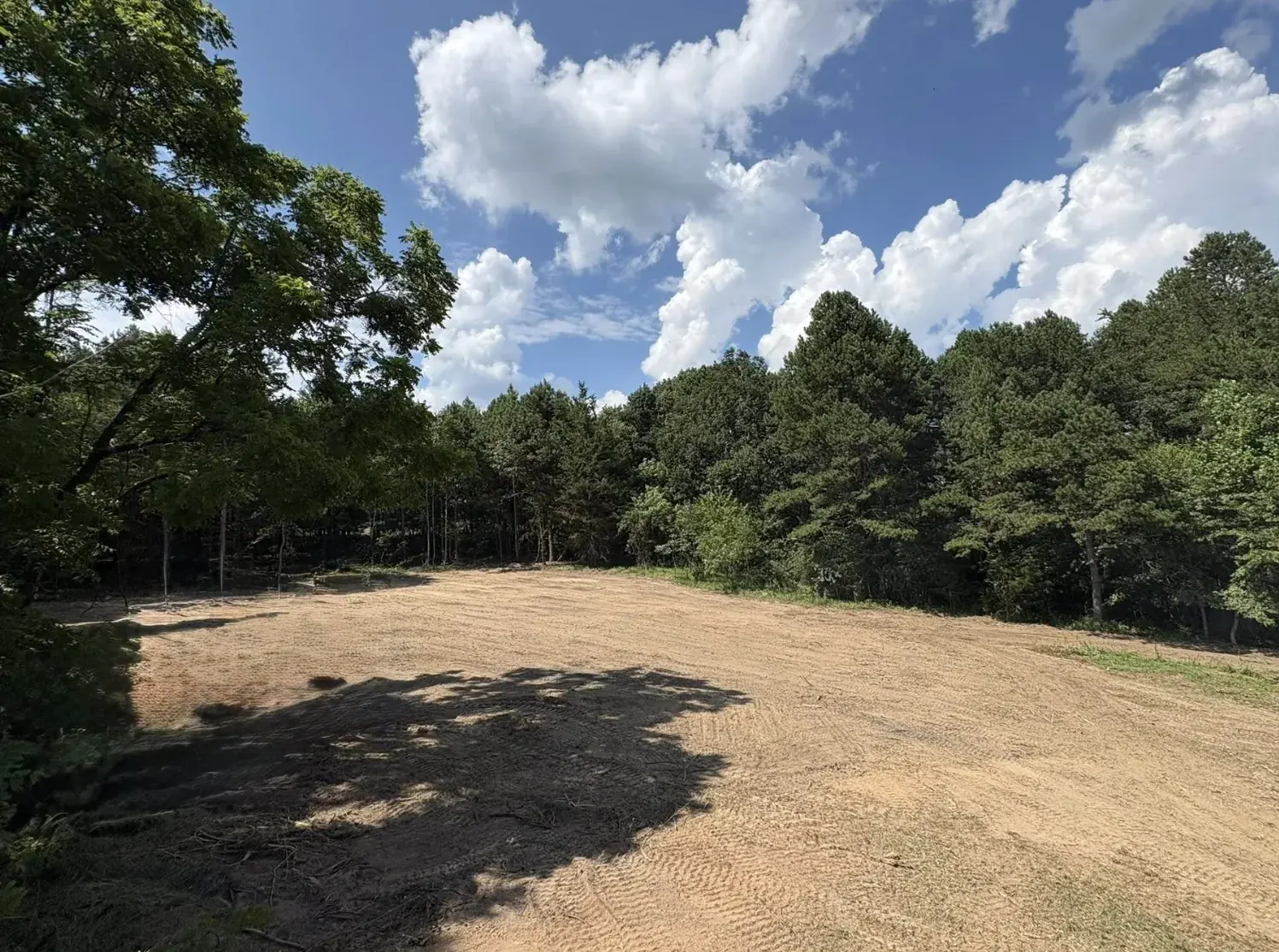 An open field left clean and level after clearing &mdash; Little Acres Grading