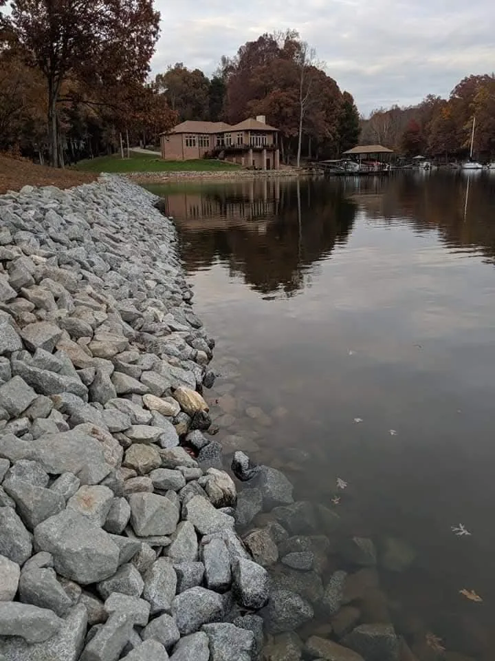 Rip-rap set along a lake shoreline to stop bank erosion &mdash; Little Acres Grading